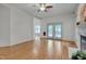 Bright living room with hardwood floors, fireplace, ceiling fan, and access to the outdoor deck at 2312 Shallowford Ln, Chapel Hill, NC 27517