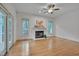 Inviting living room featuring hardwood floors, a fireplace, and natural light from large windows at 2312 Shallowford Ln, Chapel Hill, NC 27517