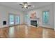 Cozy living room featuring a fireplace, hardwood floors, and access to the deck at 2312 Shallowford Ln, Chapel Hill, NC 27517