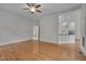 Open-concept living room with hardwood floors, ceiling fan, and easy access to kitchen area at 2312 Shallowford Ln, Chapel Hill, NC 27517