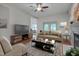 Staged living room with ceiling fan, fireplace and view into the dining area at 2312 Shallowford Ln, Chapel Hill, NC 27517