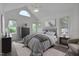 Charming bedroom with neutral palette with decorative art, furnishings, and natural light at 2312 Shallowford Ln, Chapel Hill, NC 27517