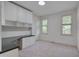 Well-lit home office space with built-in cabinets, desk, and two windows at 2312 Shallowford Ln, Chapel Hill, NC 27517