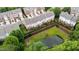Aerial view of townhomes with backyard decks overlooking a pond, providing a peaceful outdoor space at 2740 Laurelcherry St, Raleigh, NC 27612