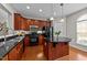 Stylish kitchen features wooden cabinets, a center island and black appliances at 2740 Laurelcherry St, Raleigh, NC 27612