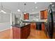 Spacious kitchen features wood cabinets, granite countertops, island and modern appliances at 2740 Laurelcherry St, Raleigh, NC 27612