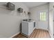 Functional laundry room equipped with a washer, dryer, and overhead shelving for storage at 2740 Laurelcherry St, Raleigh, NC 27612