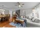 Open-concept living room and dining area featuring hardwood floors and comfortable seating at 2740 Laurelcherry St, Raleigh, NC 27612