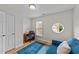 Bright office with a unique circular window, hardwood floors, and a comfortable blue sofa at 2740 Laurelcherry St, Raleigh, NC 27612