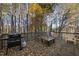 A serene deck with a grill, furniture, and a picturesque wooded backdrop, perfect for outdoor enjoyment at 2910 Barrymore St # 100, Raleigh, NC 27603