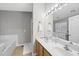 Bright bathroom with double sink vanity, large mirror, and separate tub and shower at 2910 Barrymore St # 100, Raleigh, NC 27603