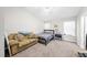 Bedroom with couch, queen bed, and natural light from the windows at 2910 Barrymore St # 100, Raleigh, NC 27603
