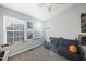 Bright bedroom with a sofa, two windows and a ceiling fan at 2910 Barrymore St # 100, Raleigh, NC 27603