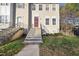 Inviting townhouse exterior with a red front door, classic windows, and well-maintained landscaping at 2910 Barrymore St # 100, Raleigh, NC 27603