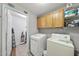 Functional laundry room with washer, dryer, shelves, and storage space at 2910 Barrymore St # 100, Raleigh, NC 27603