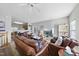 Comfortable living room features leather furniture, a ceiling fan, and lots of natural light at 2910 Barrymore St # 100, Raleigh, NC 27603