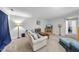Cozy living room features a comfortable sofa, lamps, TV on wooden cabinet and carpet floors at 2910 Barrymore St # 100, Raleigh, NC 27603