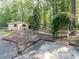 Landscaped backyard featuring a garden area and a shed at 301 Monterey Ct, Benson, NC 27504