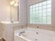 Relaxing bathroom features a soaking tub and a glass block window at 301 Monterey Ct, Benson, NC 27504