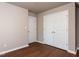 Bedroom with hardwood flooring, double closet, and neutral paint at 301 Monterey Ct, Benson, NC 27504