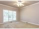 Spacious bedroom features a large window and plush neutral carpeting at 301 Monterey Ct, Benson, NC 27504