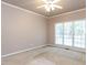 Spacious bedroom features a large window and plush neutral carpeting at 301 Monterey Ct, Benson, NC 27504