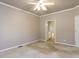 Spacious bedroom featuring plush neutral carpeting with ensuite bathroom access at 301 Monterey Ct, Benson, NC 27504