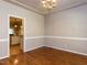 Dining room featuring hardwood floors, wainscoting, and an elegant chandelier at 301 Monterey Ct, Benson, NC 27504