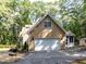 View of the two-car garage with an attached home and driveway at 301 Monterey Ct, Benson, NC 27504