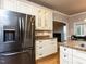 Kitchen featuring stainless steel fridge, granite countertops, and open view to living room at 301 Monterey Ct, Benson, NC 27504