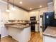 Well-lit kitchen with granite countertops and stainless steel appliances at 301 Monterey Ct, Benson, NC 27504