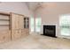 Spacious living room with a fireplace, built-in cabinets, and vaulted ceilings at 301 Monterey Ct, Benson, NC 27504