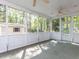 Bright screened porch with large windows offering wooded views and natural light at 301 Monterey Ct, Benson, NC 27504