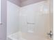 Bright bathroom featuring shower with built-in bench and hand-held shower head at 301 Monterey Ct, Benson, NC 27504