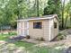Well-maintained storage shed with white trim and a cozy, organized exterior at 301 Monterey Ct, Benson, NC 27504