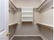 Well-organized walk-in closet with shelves and wooden hanging rods offers ample storage at 301 Monterey Ct, Benson, NC 27504