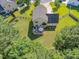 Aerial shot of the home featuring a spacious backyard with a patio area, garden, and surrounding trees at 303 Sylvias Ct, Durham, NC 27703