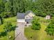 Aerial view of the home, yard, driveway, and surrounding landscaping at 303 Sylvias Ct, Durham, NC 27703