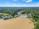 An aerial view showcasing the community's amenities, including the lake, pool, clubhouse, tennis and basketball courts at 303 Sylvias Ct, Durham, NC 27703