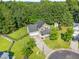 Aerial view of the home and yard surrounded by mature trees and a shed at 303 Sylvias Ct, Durham, NC 27703