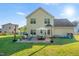 View of the backyard with a patio furnished with an outdoor dining set and seating area, perfect for entertaining at 303 Sylvias Ct, Durham, NC 27703