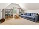 Bright bonus room featuring carpet floors, a couch, and shelving for storage at 303 Sylvias Ct, Durham, NC 27703