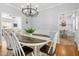 Open dining room area with view to the living room, a chandelier, and hardwood floors at 303 Sylvias Ct, Durham, NC 27703