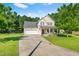 Charming two-story home featuring landscaped yard, inviting front porch, and attached two-car garage at 303 Sylvias Ct, Durham, NC 27703