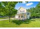 Charming two-story home featuring a landscaped yard, rocking chair front porch and attached two-car garage at 303 Sylvias Ct, Durham, NC 27703