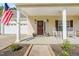 Inviting front porch with white rocking chairs, planters, ceiling fan and tasteful decor at 303 Sylvias Ct, Durham, NC 27703