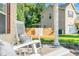 Cozy porch featuring white rocking chairs and a wooden swing with decorative pillows at 303 Sylvias Ct, Durham, NC 27703