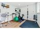 Home gym with workout equipment, including stationary bike, treadmill, free weights, and a TV at 303 Sylvias Ct, Durham, NC 27703