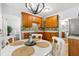 Kitchen with wooden cabinets, backsplash, stainless steel dishwasher, and an eat-in breakfast nook at 303 Sylvias Ct, Durham, NC 27703
