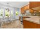 Bright kitchen with wood cabinets, stainless steel appliances, and a breakfast table near the windows at 303 Sylvias Ct, Durham, NC 27703